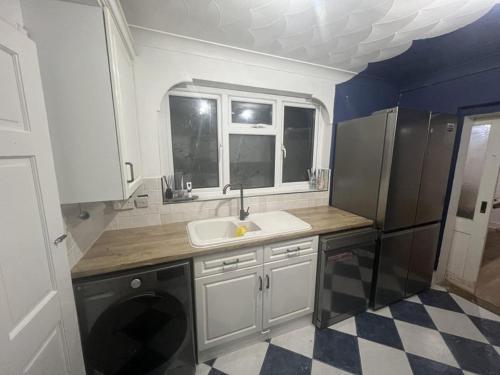 a small kitchen with a sink and a refrigerator at Gravesend Central - Spacious & Quiet Rooms in Gravesend