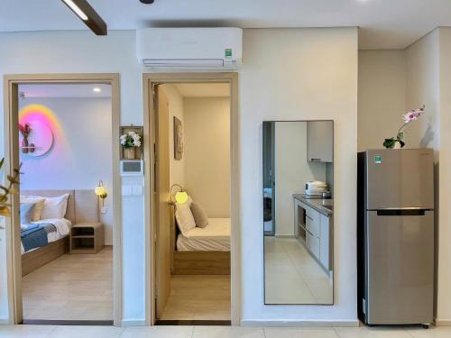 a kitchen and a living room with a refrigerator at The Song Apartment - Căn Hộ Du Lịch 5 Sao Cạnh Biển Vũng Tàu in Vung Tau