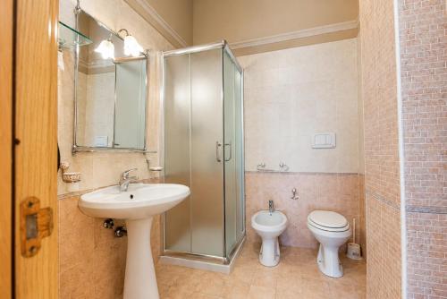a bathroom with a sink and a toilet and a shower at Tenuta Masseria del Gallo in Calimera