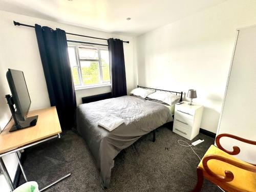 a small bedroom with a bed and a window at Rest & Recover in Wednesbury