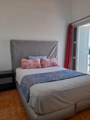 a bedroom with a bed with pink pillows on it at calm appart in Agadir