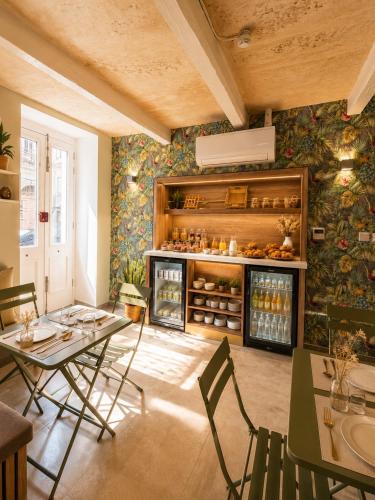 a room with a table and chairs and a refrigerator at Kappuccini Hill boutique hotel - By Tritoni Hotels in Il-Furjana