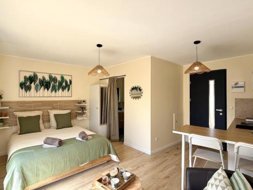 a bedroom with a bed and a desk and a table at Le Cocon de May entre Terre et Mer a proximité de caen in May-sur-Orne