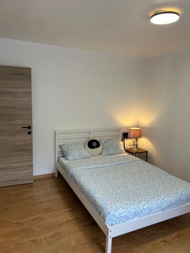 a bedroom with a bed with a blue comforter at MAISON 4 CHAMBRES et 4 GRANDS LITS in Liège