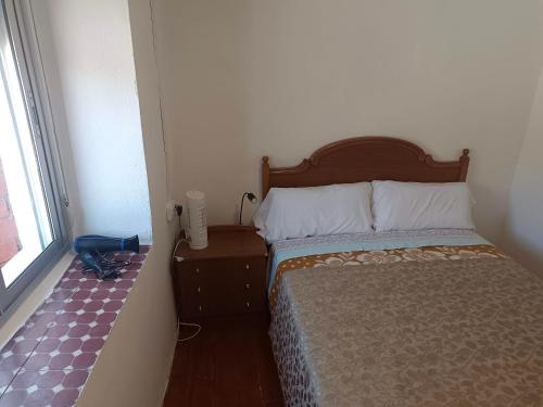 a bedroom with a bed and a window at casa SARMA in Las Médulas
