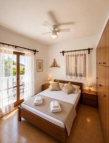 a bedroom with a bed with two towels on it at Casa di Ricci Paros in Dhragoulás