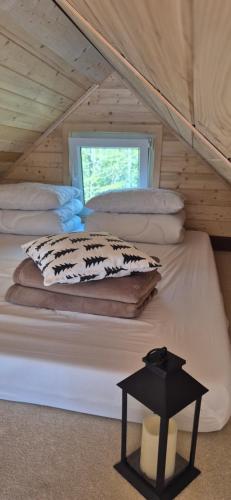 a bed in a room with a window at Odskocznia bliżej lasu in Korczyna