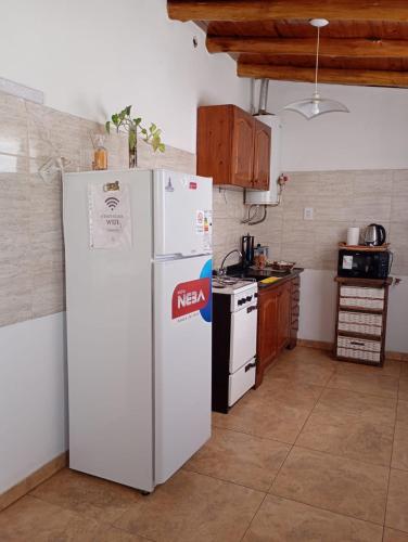 a kitchen with a refrigerator and a stove at Casa VYB in Malargüe