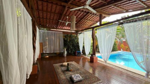 a living room with a pool in a house at The Inner Light Yoga Lodge in Sámara