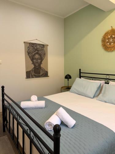 a bedroom with a bed with two towels on it at Lemon Tree Apartment in Chios