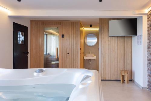 a bathroom with a tub and a sink at Holiday Residence Banfi in Štrigova
