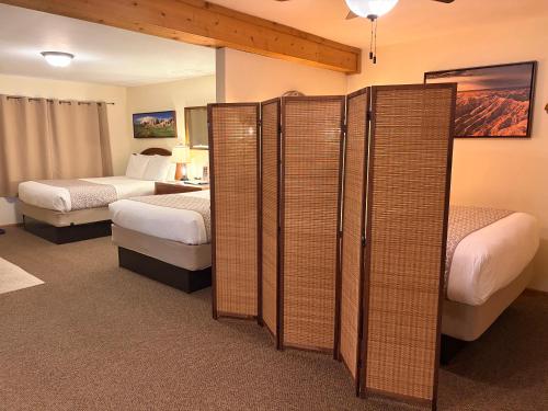 a hotel room with two beds and dividers at Whitetail Creek Resort in Lead