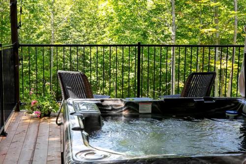 a pool of water with two chairs in it at Pur Nature et Spa Eastman in Eastman