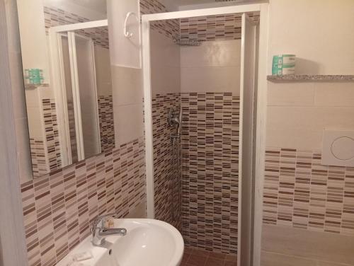 a bathroom with a sink and a shower at Europa in Alghero