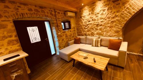 a living room with a couch and a table at Casa Stratigos in Corfu