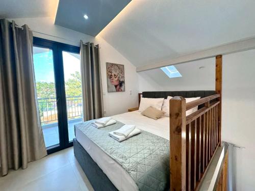 a bedroom with a bed and a balcony at Mimoza Apartments in Limenaria
