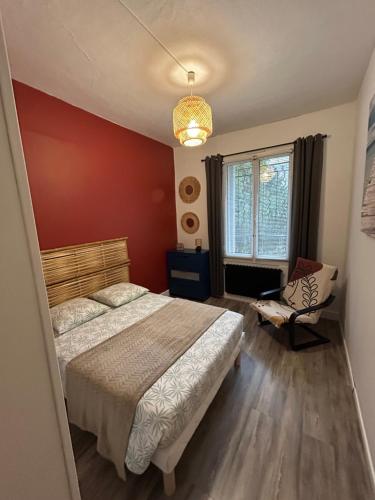 a bedroom with a bed and a chair and a window at Madras in Sète