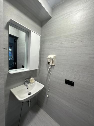 a bathroom with a sink and a mirror at Toidze's apartment1 in Kobuleti