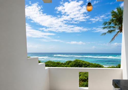 a view of the ocean from the balcony of a house at Blue Waves Ocean Mirissa in Mirissa