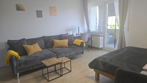 a living room with a couch and a table at InnJoy! in Friedrichshafen