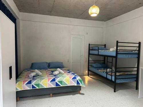 a bedroom with a bed and two bunk beds at SOPHIA Hotel Ureki in Ureki