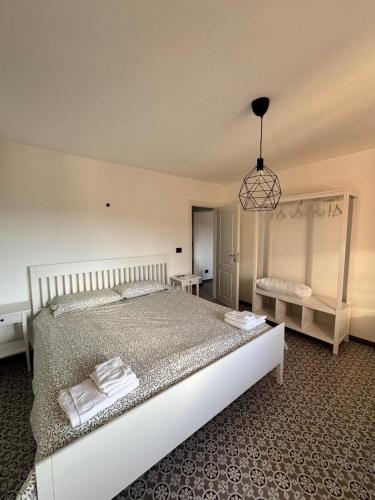 a bedroom with a large bed and a pendant light at Tattoo Home in Martone