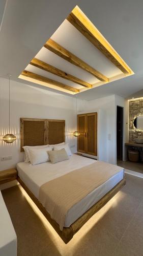 a bedroom with a large bed in a room at Pyrgianos Suites - Private Plunge Pool in Naxos Chora