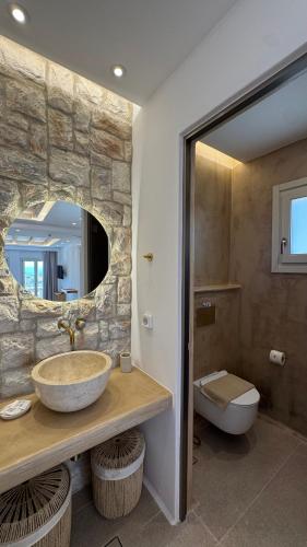 a bathroom with a sink and a toilet at Pyrgianos Suites - Private Plunge Pool in Naxos Chora