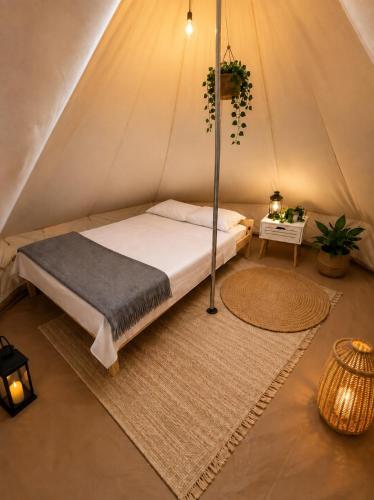 a bedroom with a bed in a tent at VaMood in Vama Veche