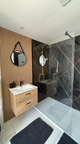 a bathroom with a sink and a mirror at La Parenthèse in Sangatte