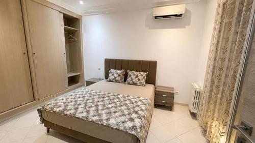 a bedroom with a bed in a room at Residence Golden Beach au bord de la mer in Bin Rhilouf