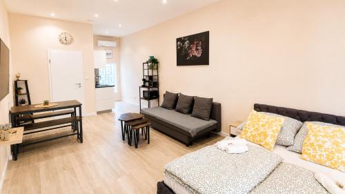 a living room with a couch and a table at Subway Apartment in Koblenz