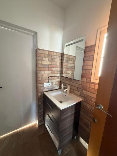 a bathroom with a sink and a mirror at San Calixto 8 in Sanlúcar de Barrameda