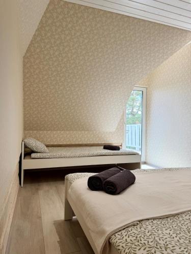 a bedroom with two beds and a window at Orjaku Sadamavaade in Orjaku