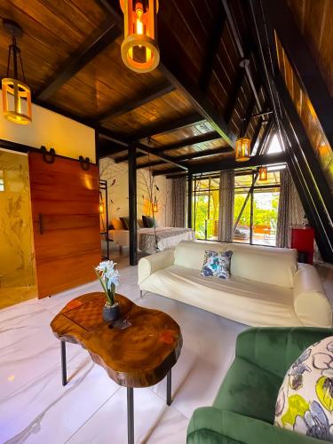 a living room with a bed and a coffee table at Suites Casa ColibrÍ in Mindo