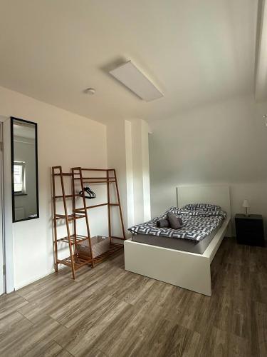 a bedroom with a bed and a ladder in it at Sweethome - Köln Messe in Bergisch Gladbach