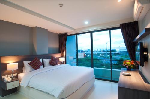 Un pat sau paturi într-o cameră la VC Residence - Chon Buri