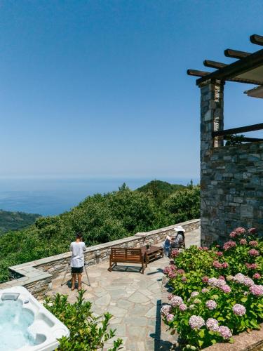a group of people standing next to a jacuzzi at A Dream Deferred villa Pelion in Kissos