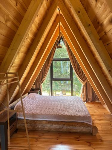 a bed in a room with a window at Villa Tara in Žabljak