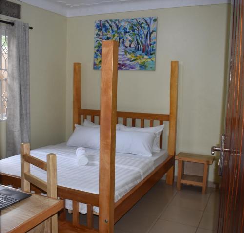 a bedroom with a bunk bed and a laptop on a desk at MildVille Apartments in Hoima