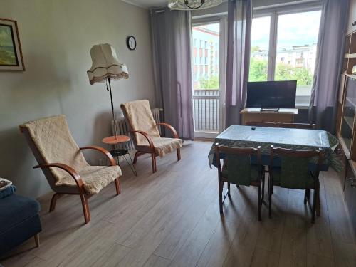 a living room with a table and chairs at Apartamenty Iława in Iława