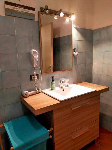 a bathroom with a sink and a mirror at B&B Meladormo in Tempio Pausania