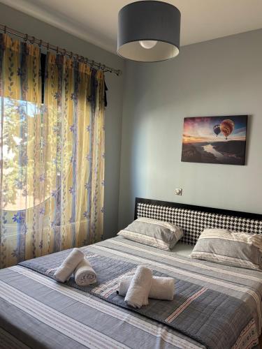 a bedroom with a large bed with towels on it at Thetis I in Alexandroupoli