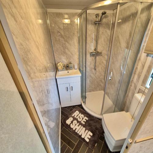 a bathroom with a shower and a sink and a toilet at No 26 Mountain View in Cockermouth