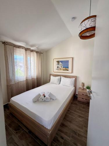 a bedroom with a bed with a stuffed animal on it at Sonia in Leptokarya
