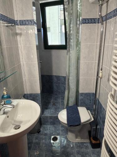 a bathroom with a sink and a shower and a toilet at Thetis I in Alexandroupoli
