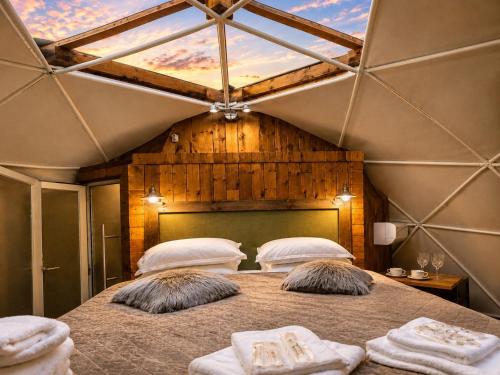 a bedroom with a large bed with two pillows at Soho-place in Bran