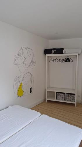 a bedroom with a bed with a drawing on the wall at Historische Villa mit Drachenfels-Blick in Bad Honnef am Rhein
