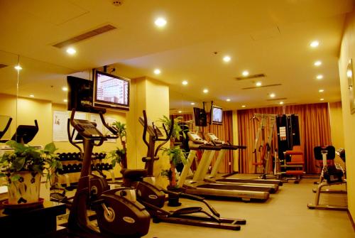a gym with several treadmills and exercise bikes at Jianguo Qianmen Beijing in Beijing