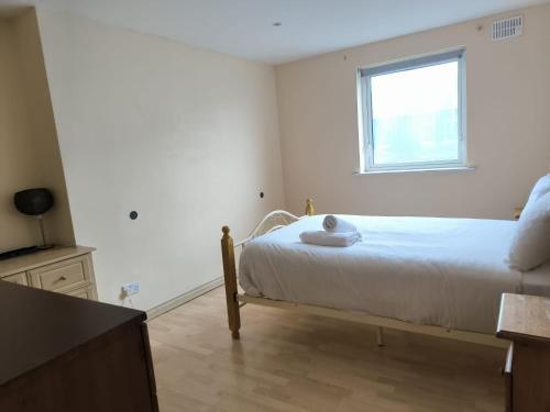 a small bedroom with a bed and a window at Salthill Gem in Galway